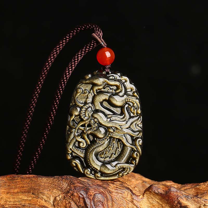 Gold Sheen Obsidian Dragon Pendant – Carved Chinese dragon with golden flash on black stone, red bead, prosperous