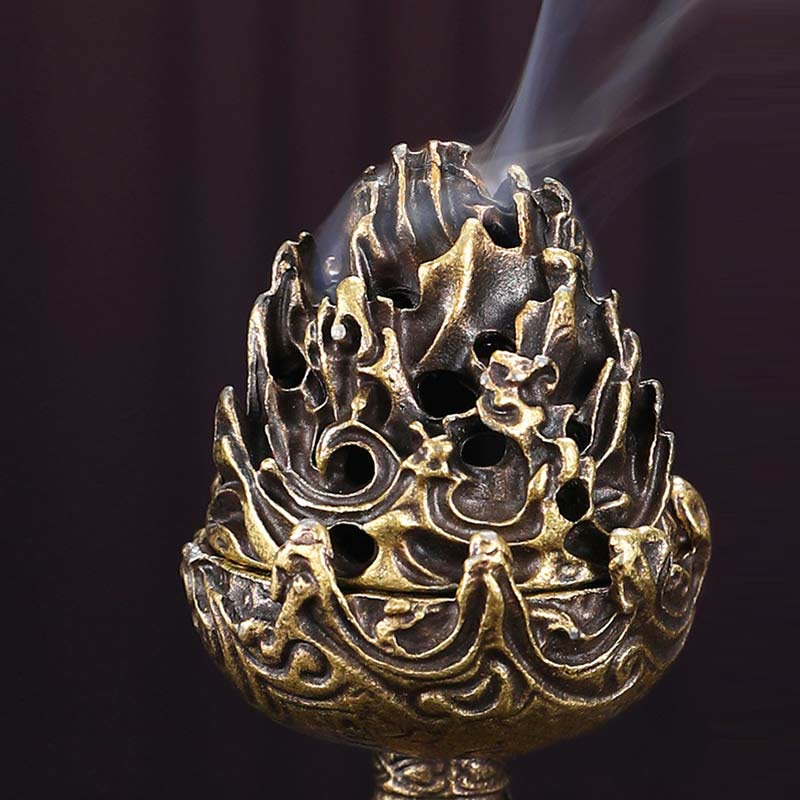 Bronze Mountain Censer – Low angle with smoke rising through pierced lid on black backdrop, warm metallic highlights