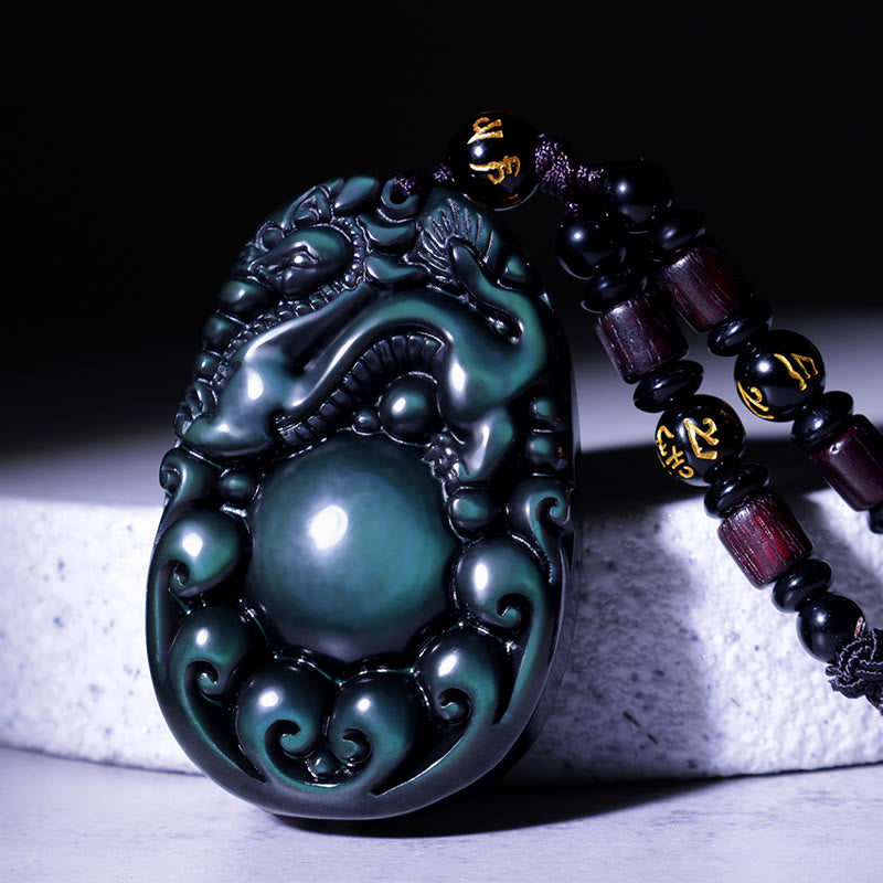 Tibetan Rainbow Obsidian PiXiu Necklace – close-up carved PiXiu with green iridescent sheen, black cord, feng shui wealth necklace