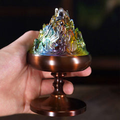 Crystal Mountain Incense Burner – iridescent mountain lid on bronze stem held in hand, crystal incense holder