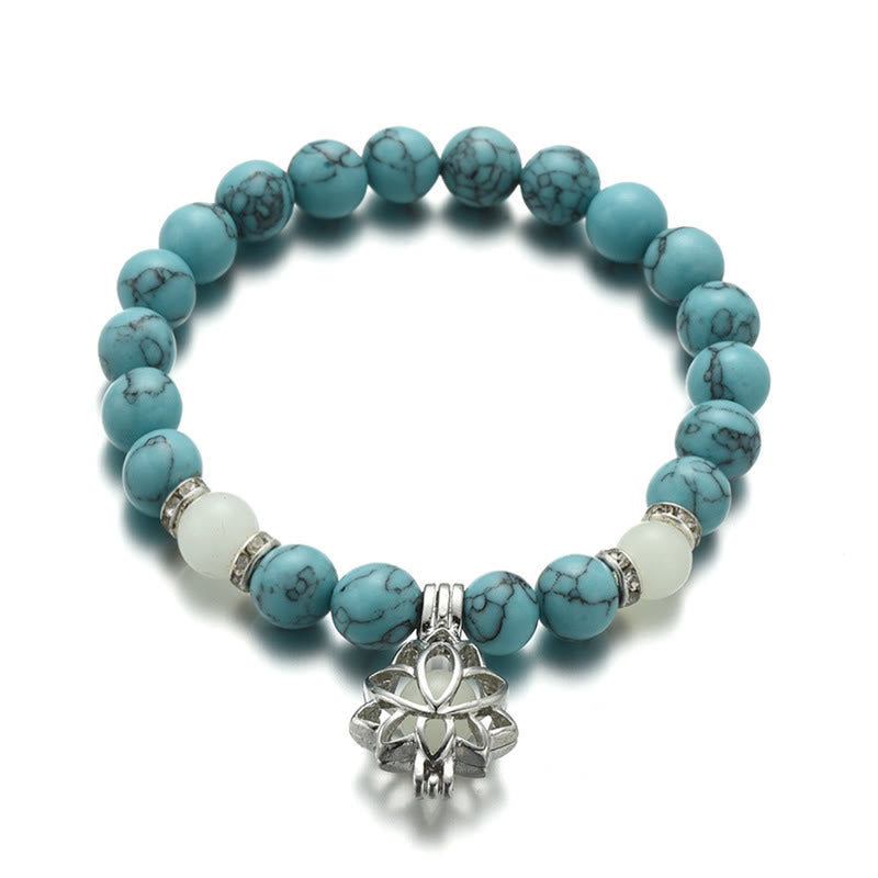 Tibetan Turquoise Glowstone Lotus Bracelet – turquoise beads with white accent beads and lotus charm top-down, turquoise lotus
