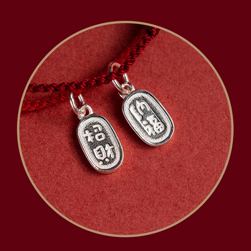 Sterling Silver Lotus Peace Buckle Red String Bracelet – Two oval silver charms with raised Chinese characters for wealth and blessing on red knotted cord, circular framed macro shot
