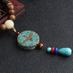 Turquoise Dzi Bead Prayer Wheel Wenge Wood Necklace - Tibetan-style pendant necklace with crushed turquoise inlay medallion, brass framework, teardrop turquoise dangle