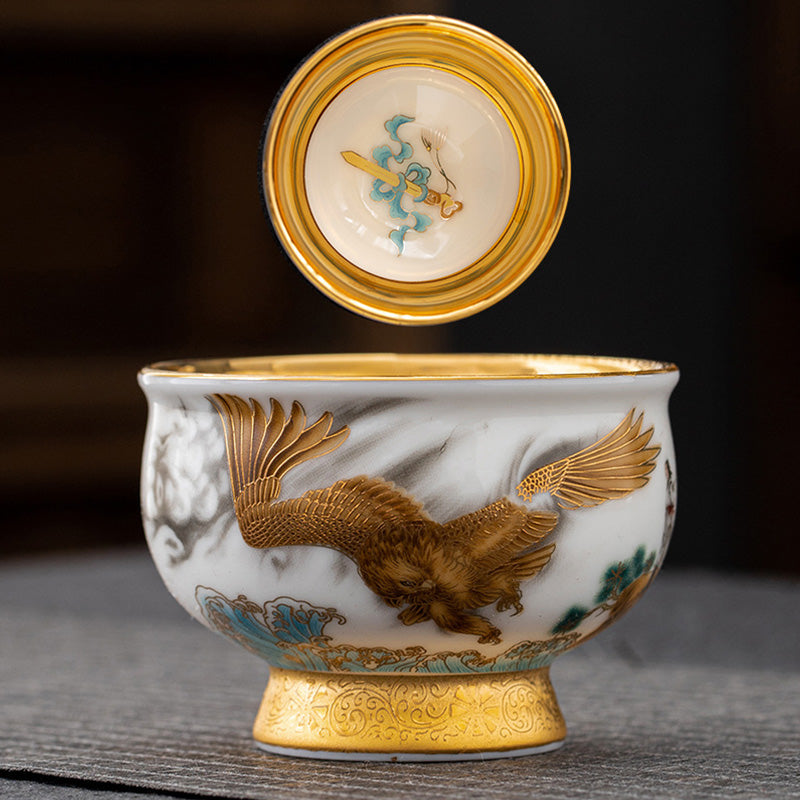 Golden Eagle Dragon Gilt Ceramic Teacup – lidded gaiwan with gold eagle relief, turquoise waves, ornate gold base, traditional