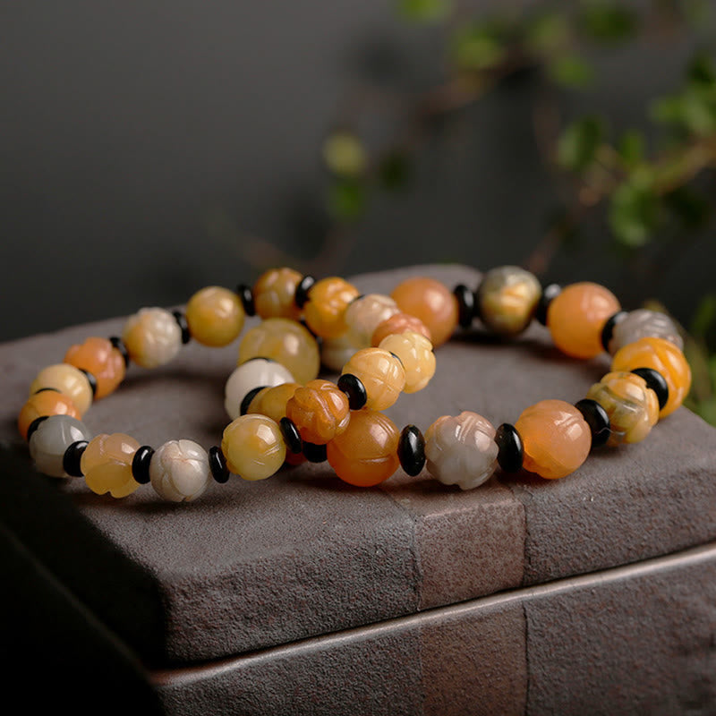Golden Silk Jade Lotus Bracelet – Carved lotus beads in honey gold tones on dark stone slab, lotus jade jewelry