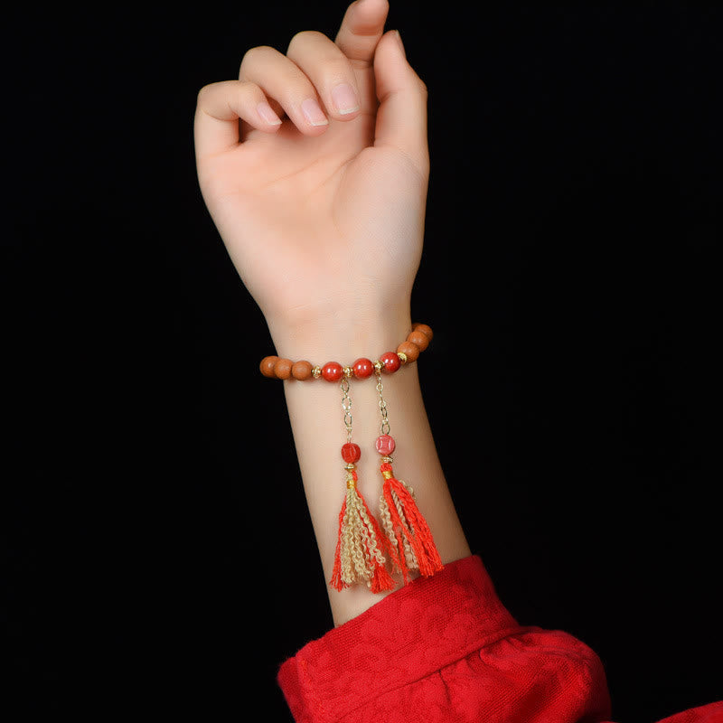 Peach Wood PiXiu Wealth Bracelet – Beaded bracelet with tassels on driftwood prop, Tibetan wealth jewelry