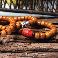Tibetan Bone Beads Om Mani Padme Hum Bracelet – wood beads with red carved and silver accents on rustic wood, ethnic bracelet