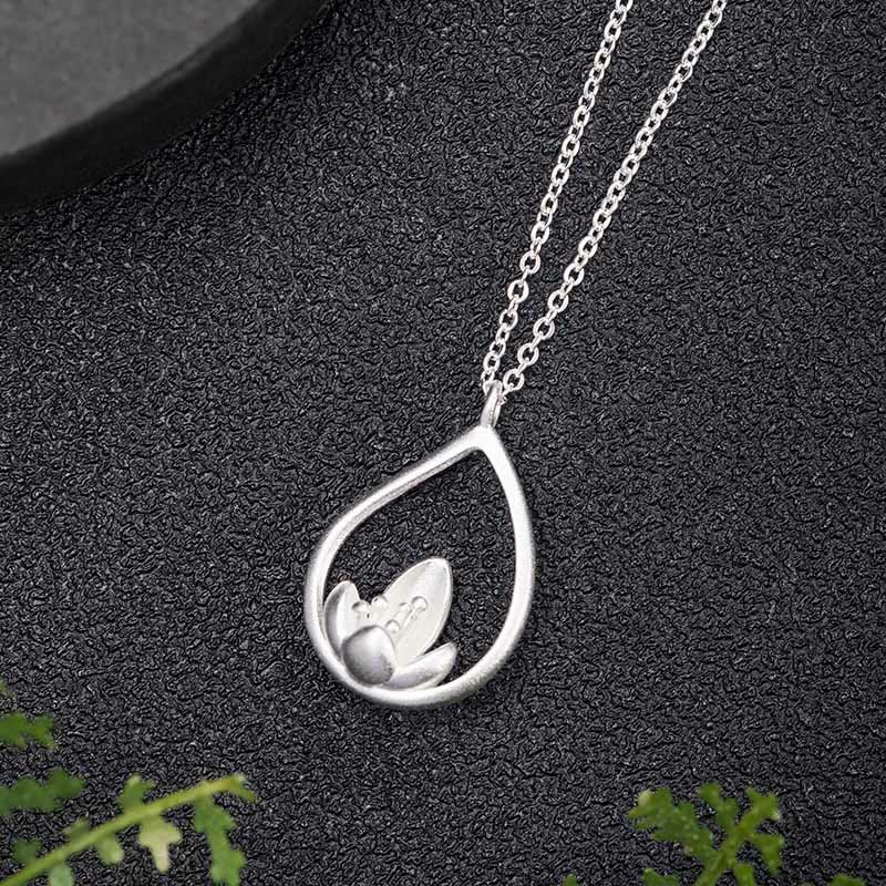 Sterling Silver Lotus Pendant – Flat lay overhead showing openwork lotus, Zen-inspired