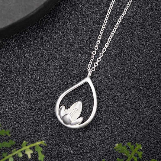 Sterling Silver Lotus Pendant – Flat lay overhead showing openwork lotus, Zen-inspired