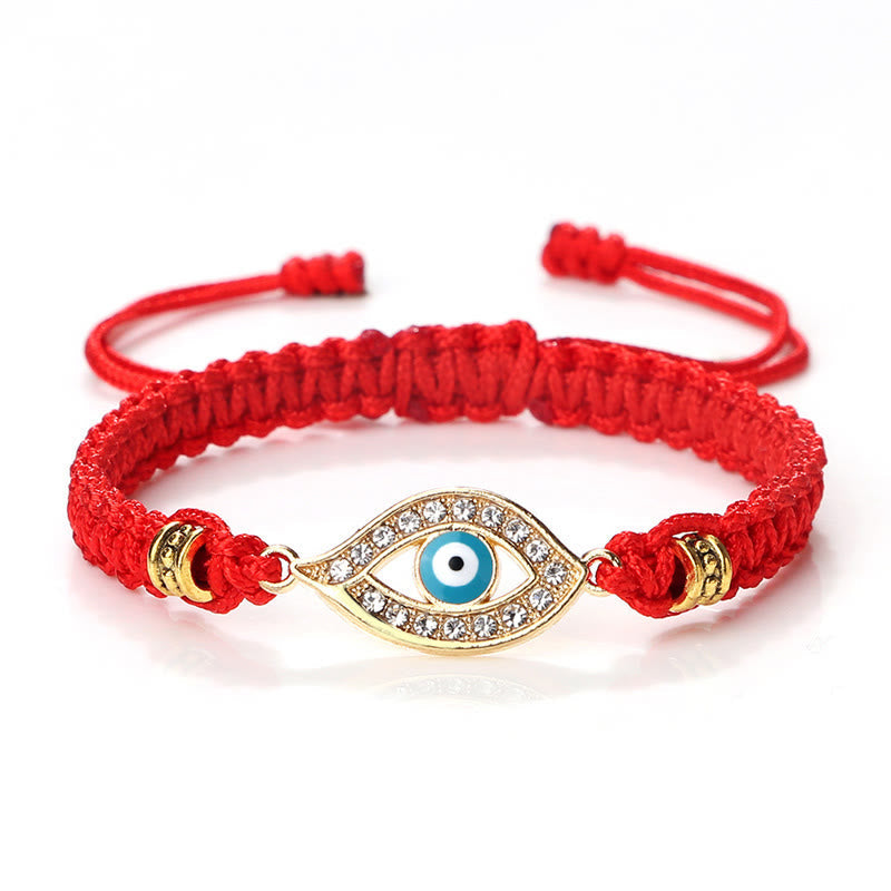 Red cord evil eye bracelet with gold crystal pave evil eye charm on white background