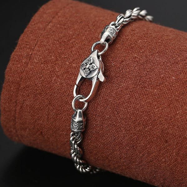 Silver Vajra Bracelet – engraved lobster clasp with cross emblem on fabric stand, Tibetan bracelet