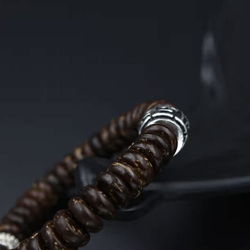Om Mani Padme Hum Coconut Shell Bracelet – diagonal macro shot, carved silver accent