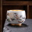 Dragon Gilt Porcelain Teacup - Gold-interior cup with ink-wash dragon on stone surface, luxurious