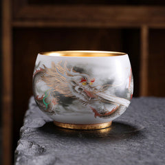 Dragon Gilt Porcelain Teacup - Gold-interior cup with ink-wash dragon on stone surface, luxurious