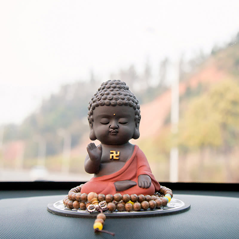 Small Buddha Purple Clay Decoration – low angle dashboard view with mala and tassels, natural daylight, road companion
