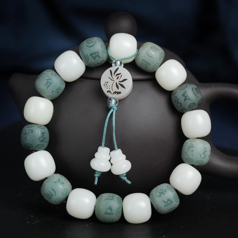 White Bodhi Seed Om Mani Padme Hum Bracelet – Drape view over teapot, green mantra bead detail