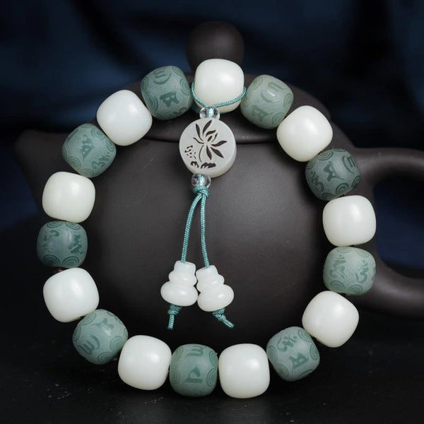 White Bodhi Seed Om Mani Padme Hum Bracelet – Drape view over teapot, green mantra bead detail