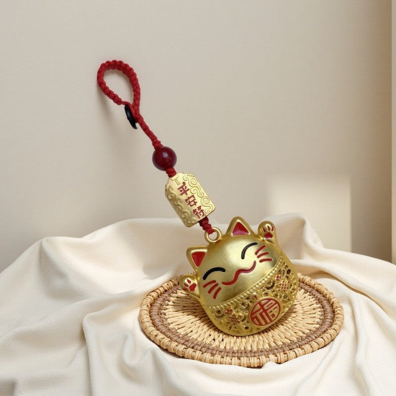 Gold enamel blue calabash keychain with Chinese knot and peace talisman, red background