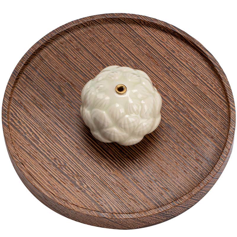 Ceramic Lotus Incense Burner top-down overhead view on dark wood tray, elegant