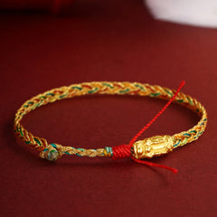 Colorful Dragon Carved Braided Bracelet – Carved gold bead on multicolor braid with red tie closure, Artisanal