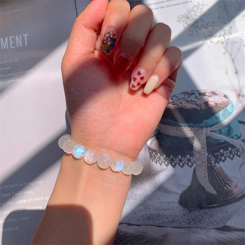 Natural Moonstone Lotus Love Bracelet - wrist shot with lifestyle props, gemstone bracelet