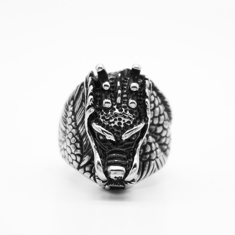 Dragon Balance Titanium Steel Ring – frontal view showing piercing eyes and crown studs, masculine