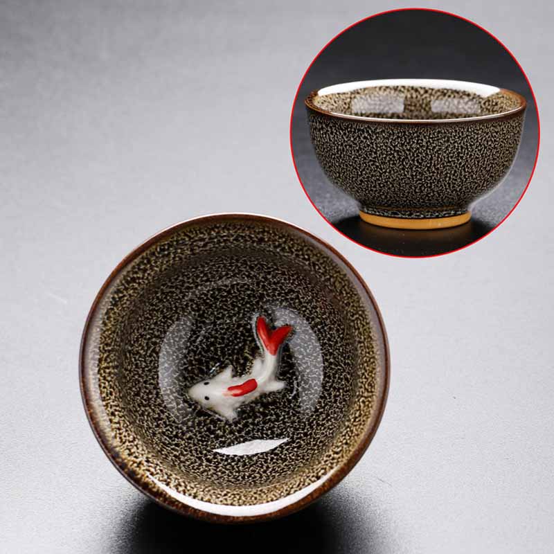 Jianzhan Koi Teacup – handleless cup held in hand showing size, kung fu tea