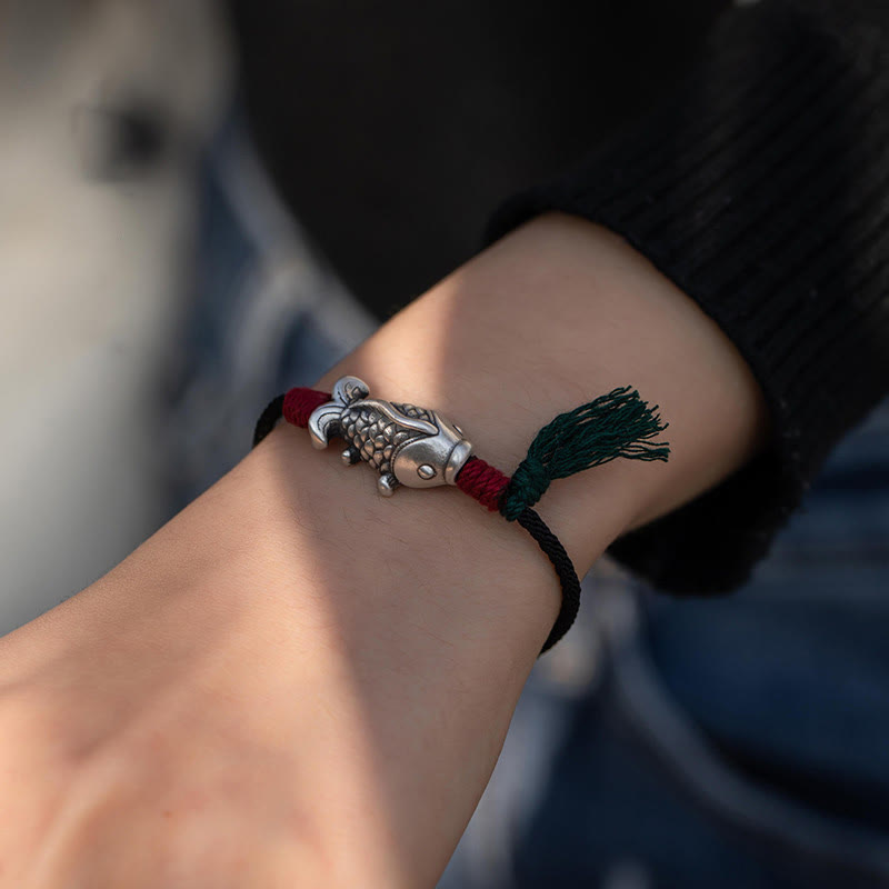 925 Sterling Silver Koi Fish Bracelet – worn on wrist with black knit sleeve, silver koi charm with scale detailing