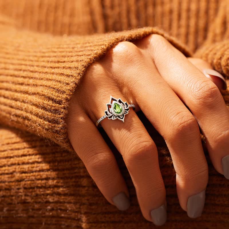 Sterling Silver Lotus Ring – Green peridot on hand with brown sweater, healing ring