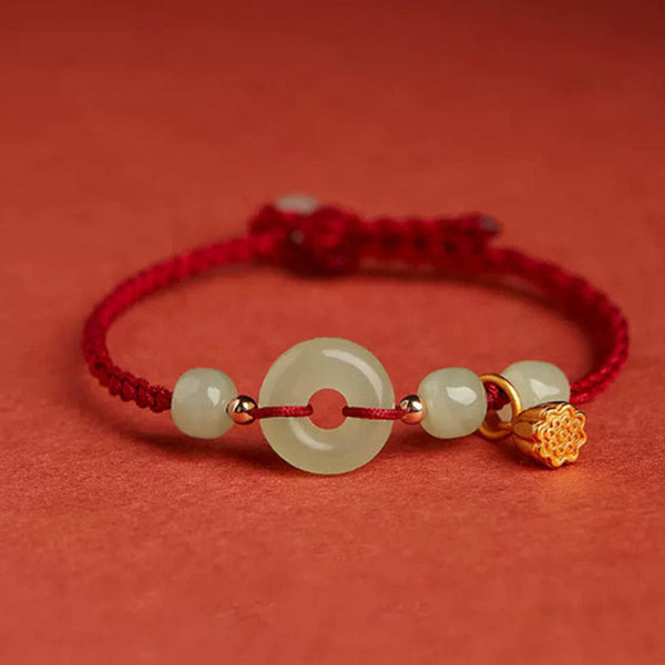 Jade Peace Buckle Lotus Bracelet – pale celadon jade bi disc with gold lotus charm on red woven cord, Protection