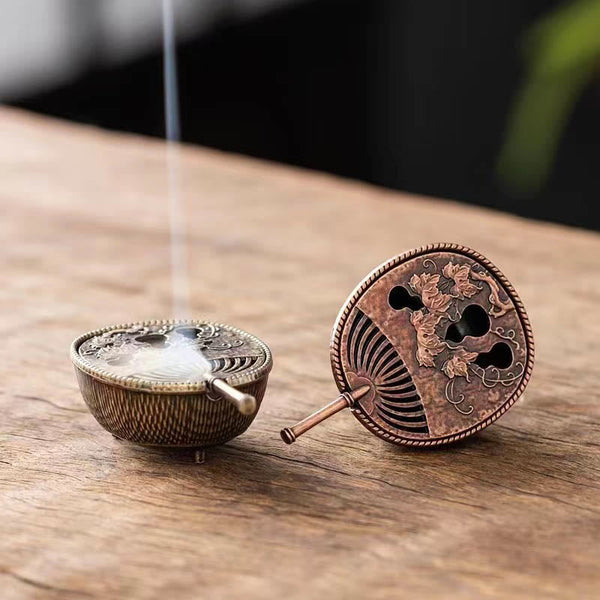 Copper Incense Burner Set – two fan-shaped metal burners, one smoking, on wooden surface