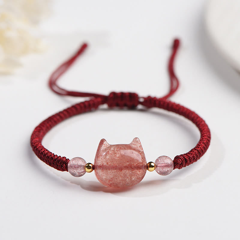 Adjustable red cord bracelet with carved pink quartz cat charm, gold accents and matching pink beads, traditional Chinese lucky cat jewelry