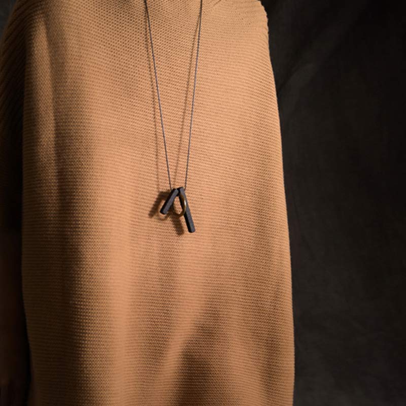 Zen Circle Ebony Wood Necklace - dark bar pendants on cord worn on tan fabric bust, minimalist design