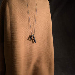 Zen Circle Ebony Wood Necklace - dark bar pendants on cord worn on tan fabric bust, minimalist design