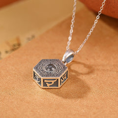 Silver Mantra Projection Necklace – Hexagonal pendant showing Sanskrit side engravings on aged paper