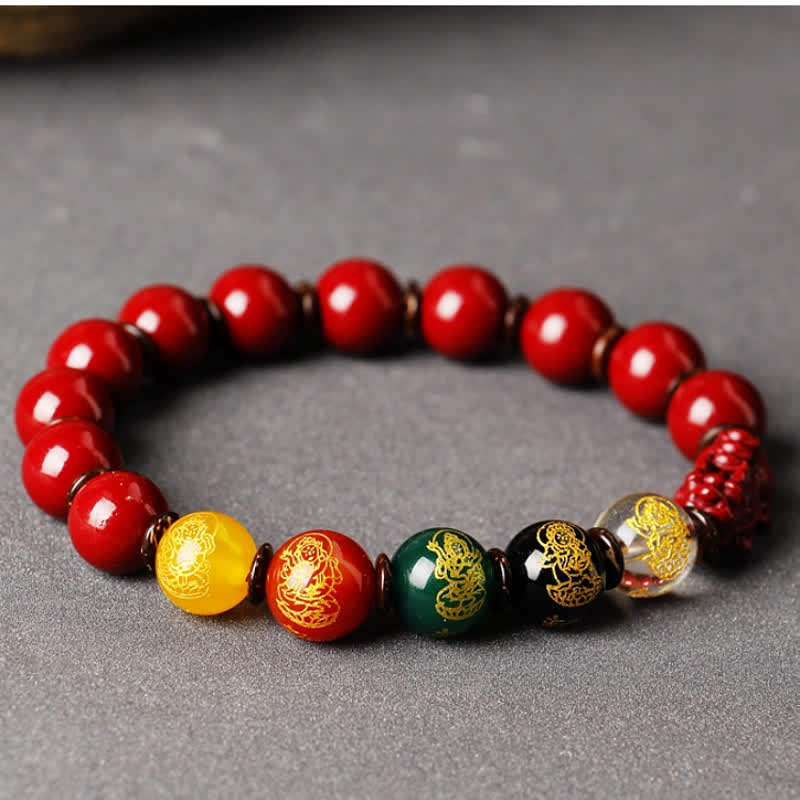 Cinnabar PiXiu Blessing Bracelet – Side view on gray showing gold-patterned multicolor beads with PiXiu