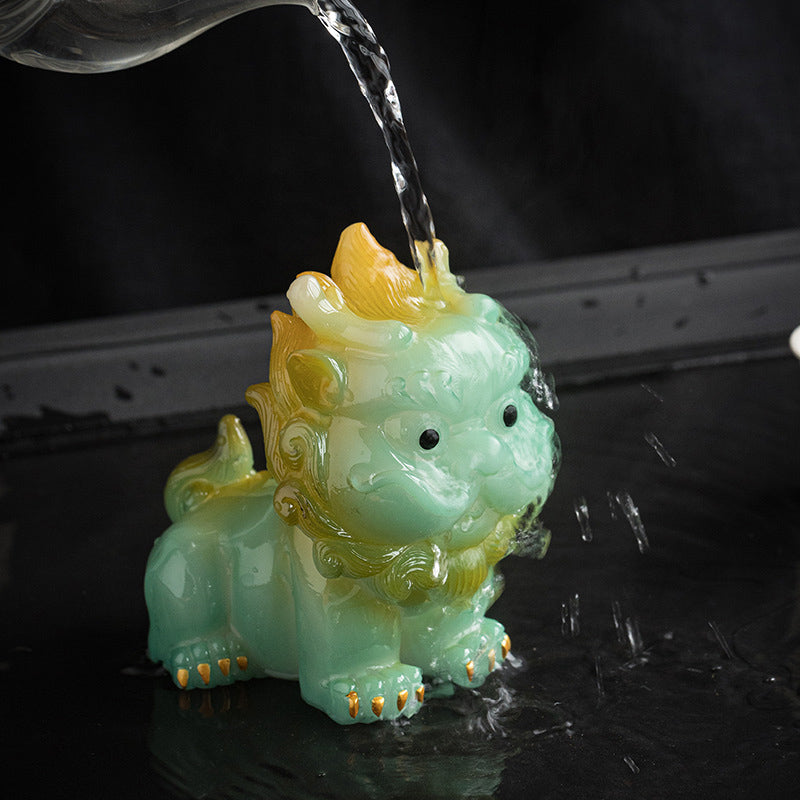 Small PiXiu Tea Pet – Light green PiXiu being watered with steam rising, tea pet ritual