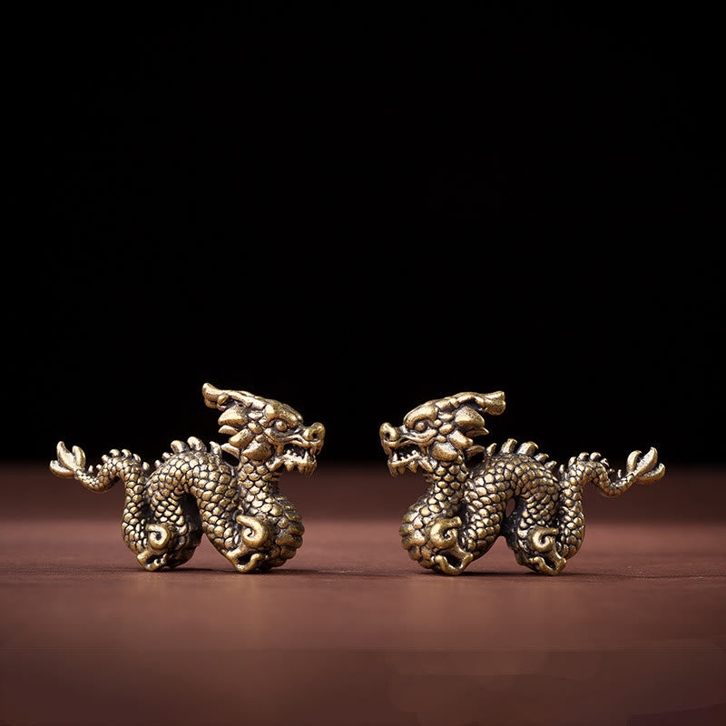 Auspicious Brass Dragon Decoration - Paired dragons facing each other on dark wood, powerful symmetry