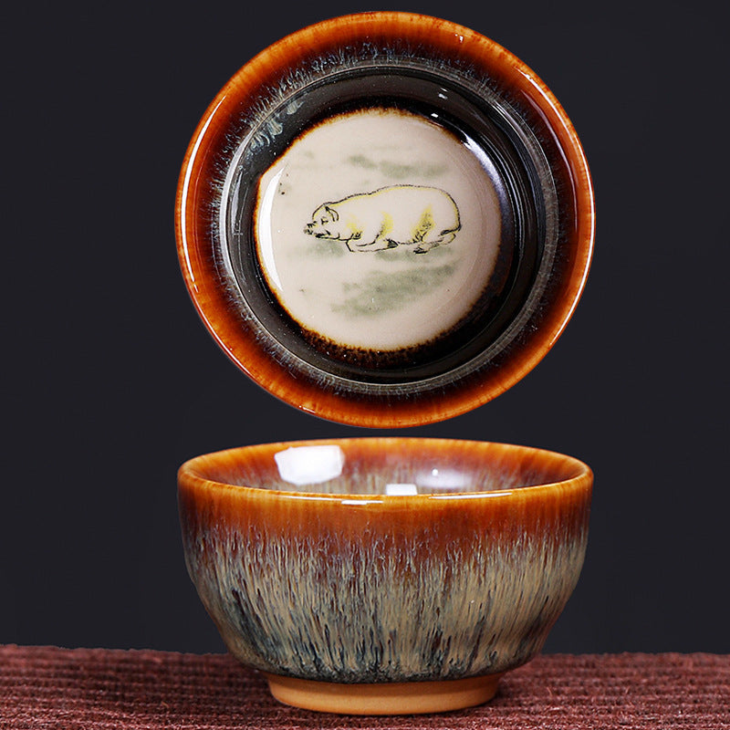 12 Zodiac Jian Zhan Teacup - tea pouring into cups revealing hidden Ox Tiger Pig zodiac art through golden amber liquid