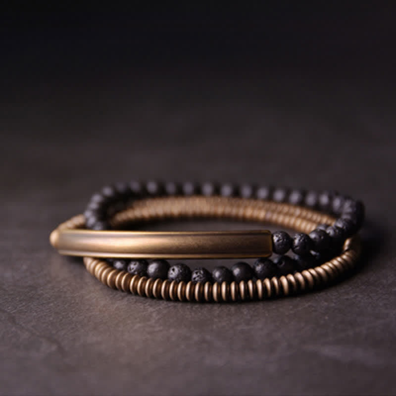Lava Rock Copper Healing Bracelet – Black lava bead bracelet with copper focal and silver accents on gray stone, product shot with e-commerce white annotation labels