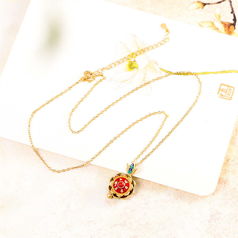 Red Agate Lotus Necklace – gold lotus pendant styled with dried flower on cream card, meaningful