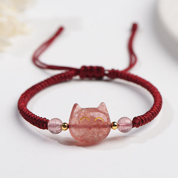 Adjustable burgundy cord bracelet with carved pink strawberry quartz cat charm, gold smiley eyes and matching pink crystal beads