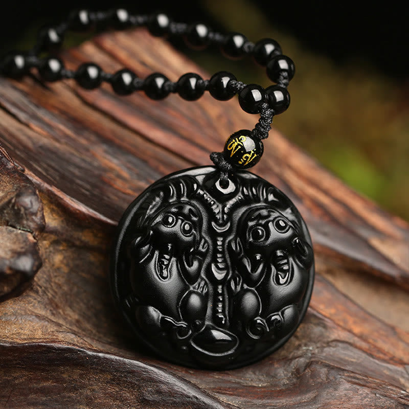 Double PiXiu Necklace – Black obsidian double PiXiu disc pendant on rope with gold bead, wooden root display