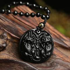 Double PiXiu Necklace – Black obsidian double PiXiu disc pendant on rope with gold bead, wooden root display
