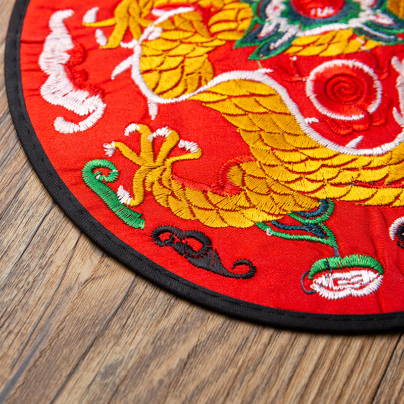 Dragon Embroidery Tea Cup Coaster Mat - red base side-profile dragon with spiral patterns, wood surface, traditional