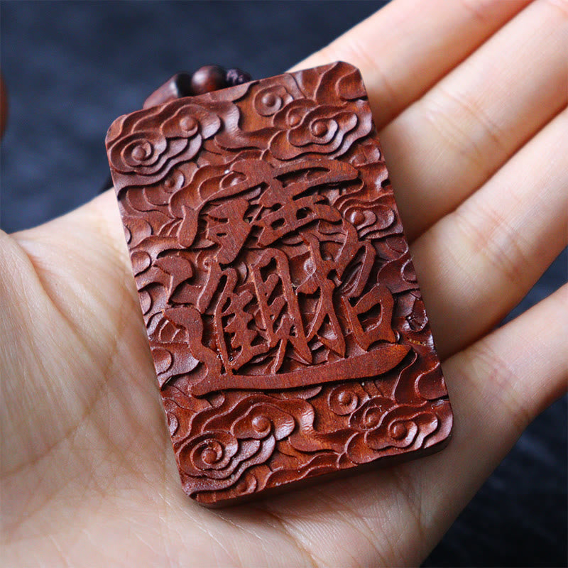 Lightning Struck Jujube Wood PiXiu – Hand holding back of pendant with fortune chars