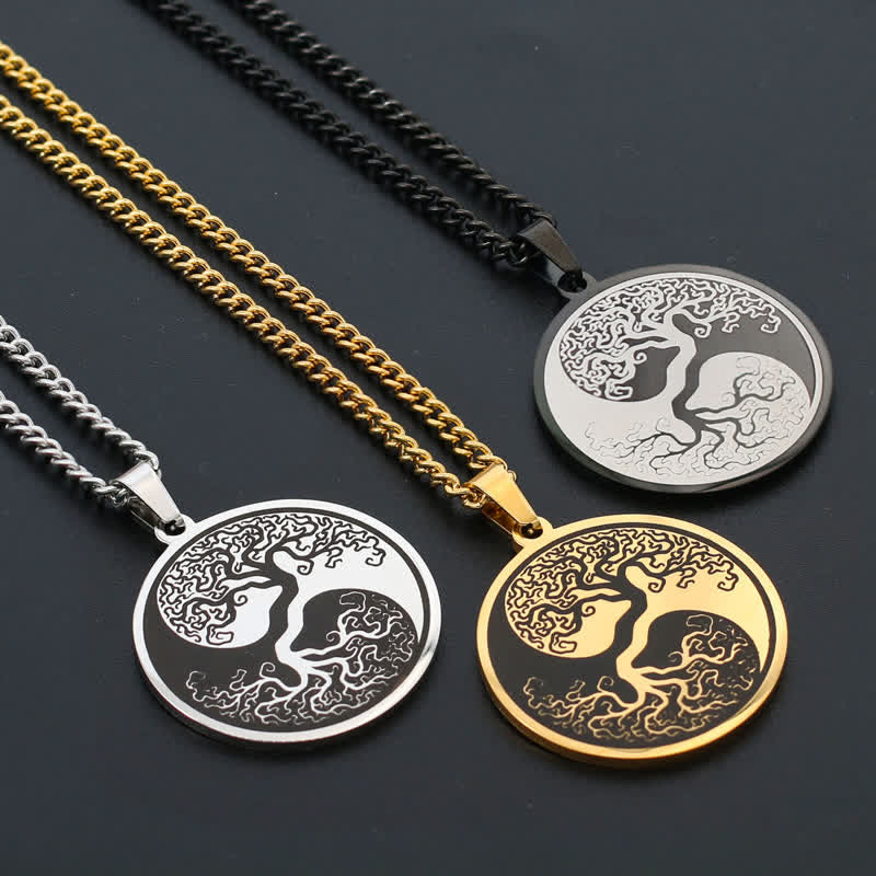 Tree of Life Titanium Steel Necklace – three variants on charcoal surface, overhead diagonal view, connection pendant