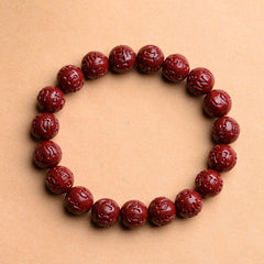 Cinnabar Om Mani Padme Hum Bracelet – mantra carved deep red beads overhead view, Tibetan prayer bracelet