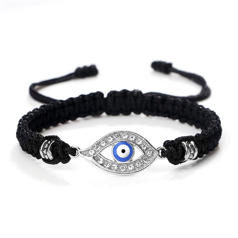 Black cord evil eye bracelet with silver blue evil eye crystal charm on white bg