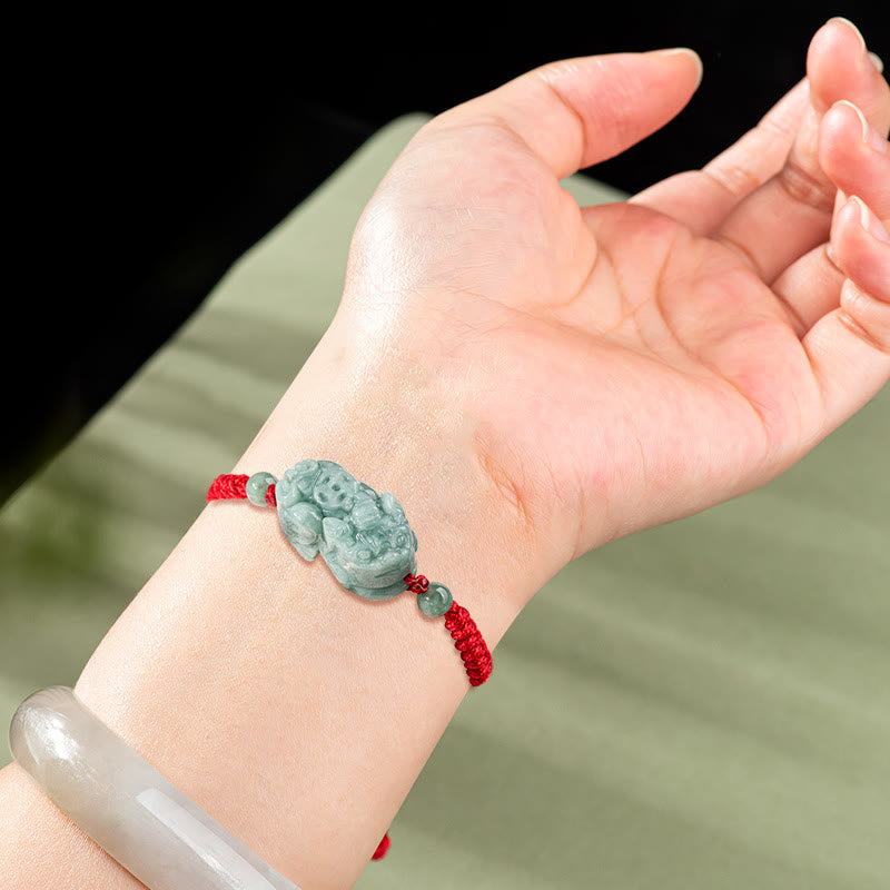 Jade PiXiu Knot Bracelet – Red braided bracelet with jade PiXiu worn on wrist, natural lighting